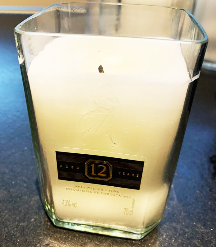 Candle poured into a cut-down whisky bottle