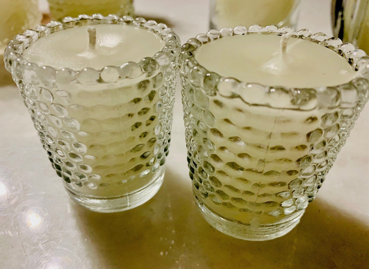 Two candles in textured bubble glass holders