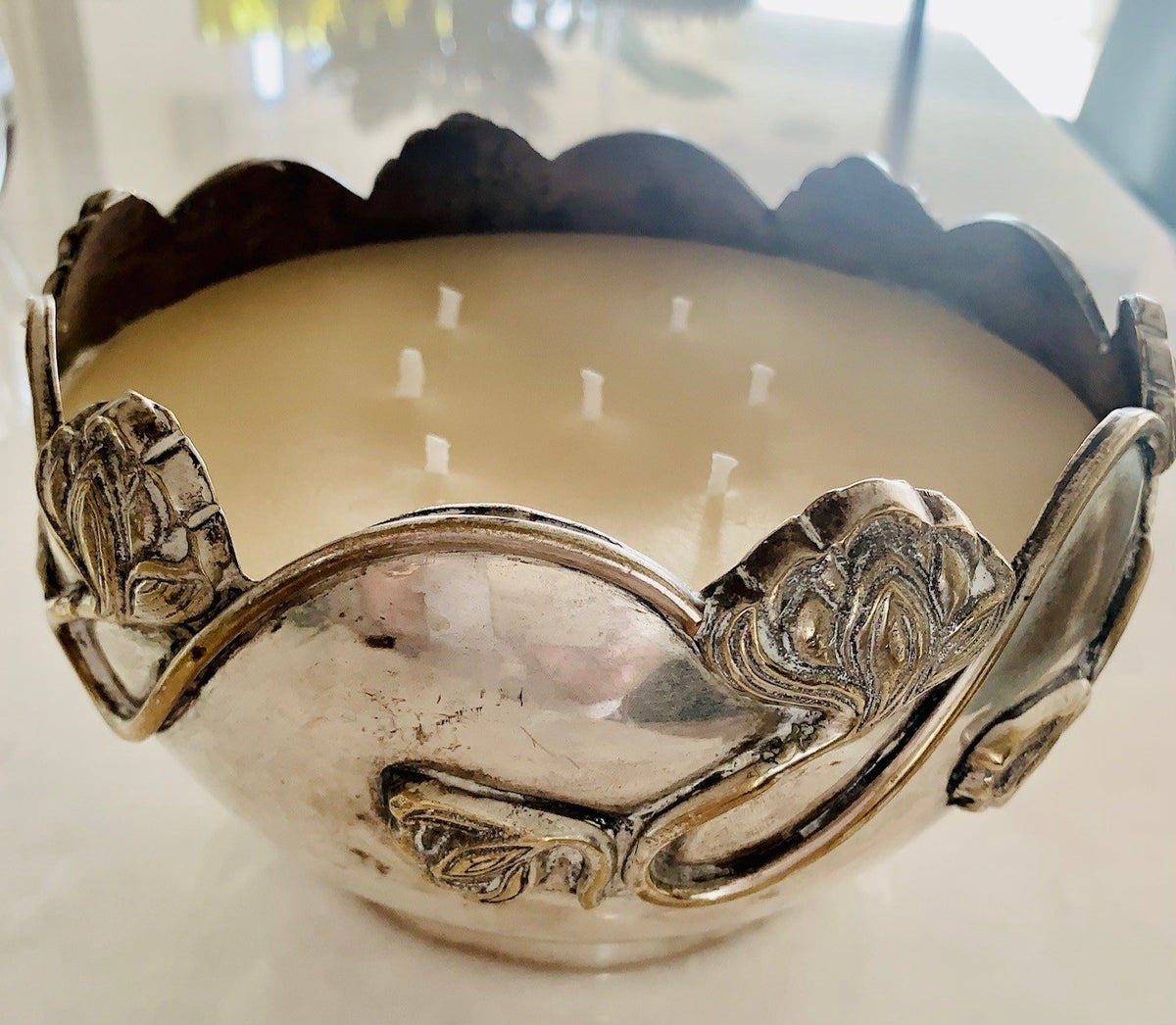 Multi-wick candle in a scalloped silver bowl